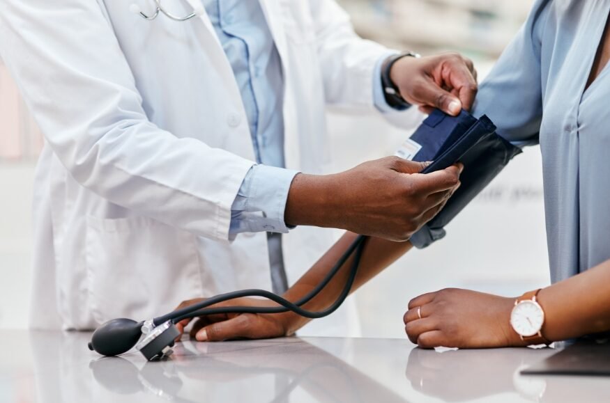 doctor taking patients blood pressure